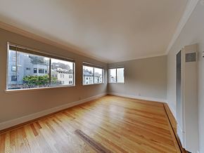 San Francisco apartment for rent - an empty living room with wood floors and large windows