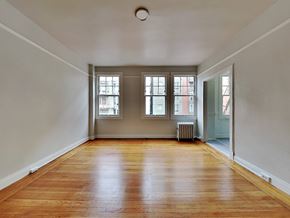 San Francisco apartment for rent - an empty living room with wood floors and windows