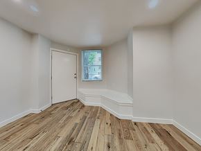 San Francisco apartment for rent - a living room with white walls and wood flooring and a window