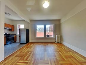 San Francisco apartment for rent - an empty living room with a large window and a kitchen