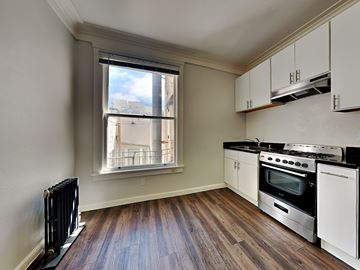 San Francisco apartment for rent - an empty kitchen with a stove and a window