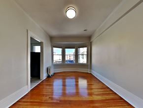 San Francisco apartment for rent - an empty living room with wood floors and a bay window