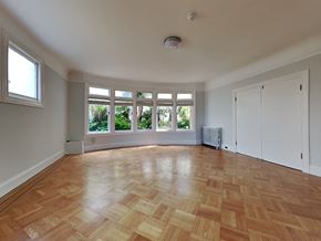 San Francisco apartment for rent - an empty living room with a large window and wooden floors