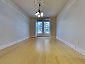 San Francisco apartment for rent - an empty living room with wood floors and a window