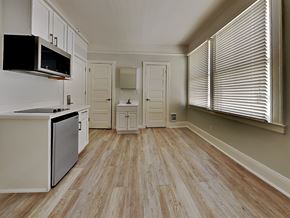 San Francisco apartment for rent - a kitchen with a stove and a microwave and a window