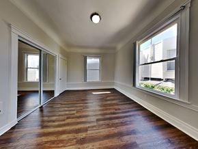 San Francisco apartment for rent - an empty living room with wood floors and a large window