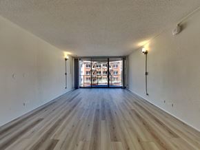 San Francisco apartment for rent - an empty living room with wood flooring and a balcony