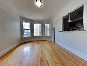 San Francisco apartment for rent - an empty living room with wood floors and a window