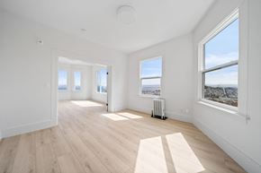 San Francisco apartment for rent - a living room with hardwood floors and three windows