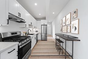 San Francisco apartment for rent - a kitchen with white cabinets and black appliances