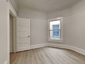 San Francisco apartment for rent - an empty bedroom with a window and a white door