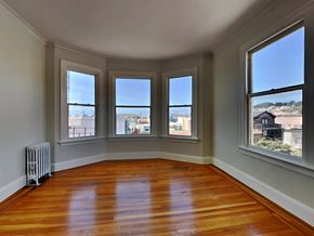 San Francisco apartment for rent - a living room with a wood floor and four windows