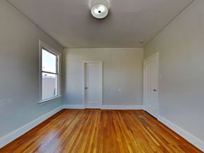 San Francisco apartment for rent - an empty living room with wood floors and a window