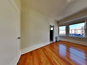 San Francisco apartment for rent - an empty living room with wood floors and a window