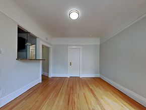 San Francisco apartment for rent - a living room with wood floors and a white door