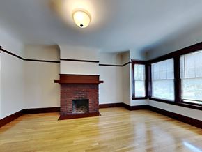 San Francisco apartment for rent - a living room with a brick fireplace and a wooden floor