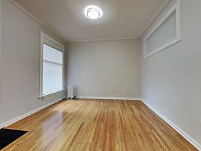 San Francisco apartment for rent - an empty living room with wood floors and a window