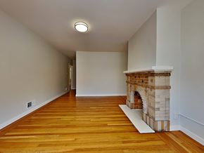 San Francisco apartment for rent - a living room with a brick fireplace and wooden floors