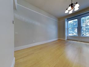 San Francisco apartment for rent - an empty living room with wood floors and a large window
