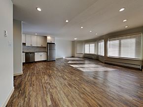 San Francisco apartment for rent - an empty living room and kitchen with wood flooring
