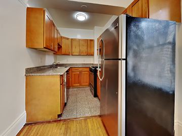 San Francisco apartment for rent - a kitchen with a stainless steel refrigerator and wooden cabinets