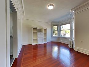 San Francisco apartment for rent - a living room with a large window and wooden floors
