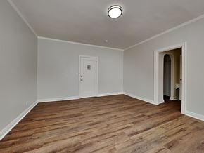 Oakland apartment for rent - a empty living room with wood floors and a white door