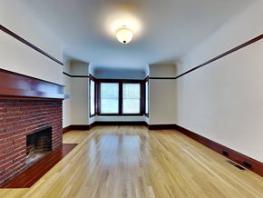 San Francisco apartment for rent - an empty living room with a brick fireplace and wooden floors