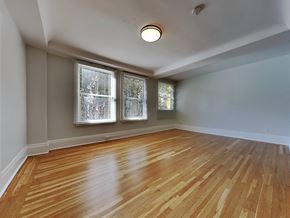 San Francisco apartment for rent - an empty living room with wood floors and three windows
