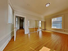 San Francisco apartment for rent - an empty living room with wood floors and a window