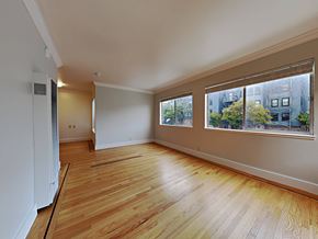 San Francisco apartment for rent - a living room with a large window and wooden floors