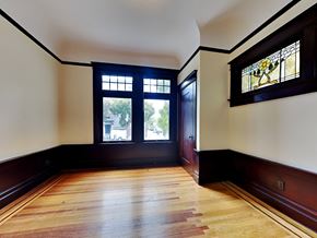 San Francisco apartment for rent - A room with a wooden floor and a stained glass window.