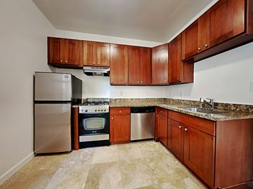San Francisco apartment for rent - a kitchen with stainless steel appliances and wooden cabinets