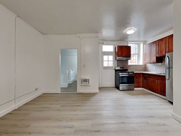 San Francisco apartment for rent - a kitchen with wooden cabinets and a stove and a refrigerator