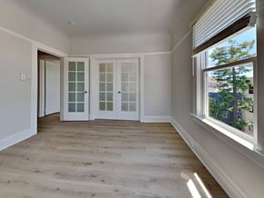 San Francisco apartment for rent - a living room with white doors and a window