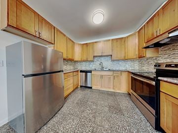 San Francisco apartment for rent - a kitchen with stainless steel appliances and wooden cabinets