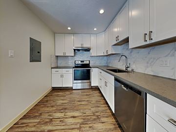 San Francisco apartment for rent - a kitchen with white cabinets and stainless steel appliances