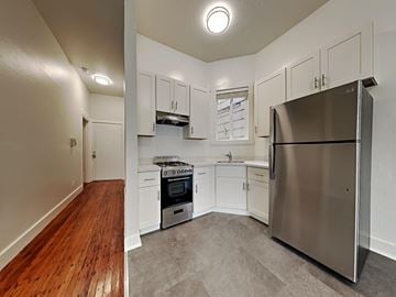 San Francisco apartment for rent - a kitchen with stainless steel appliances and white cabinets