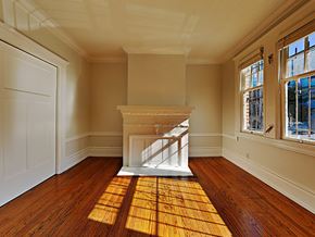 San Francisco apartment for rent - an empty living room with a fireplace and wooden floors