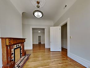 San Francisco apartment for rent - a living room with a fireplace and a door to a hallway