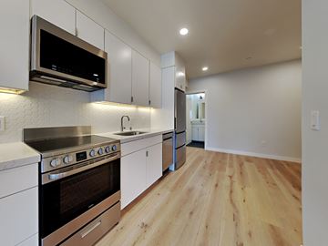 San Francisco apartment for rent - a renovated kitchen with white cabinets and stainless steel appliances