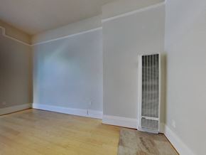 San Francisco apartment for rent - a living room with white walls and a wood floor and a radiator