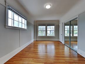 San Francisco apartment for rent - an empty living room with wood floors and a window