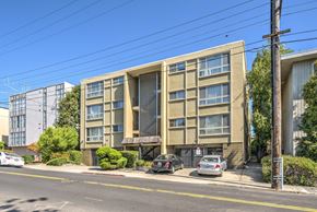 Oakland apartment for rent - an apartment building with cars parked in front of it