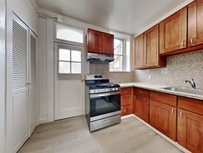 San Francisco apartment for rent - a kitchen with wooden cabinets and an oven and a sink