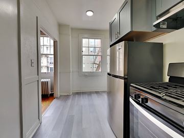 San Francisco apartment for rent - an empty kitchen with a stove and a refrigerator