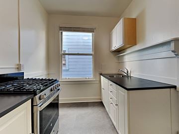 San Francisco apartment for rent - a kitchen with a stove and sink and a window