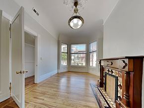 San Francisco apartment for rent - a living room with a fireplace and a door to a hallway