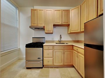 San Francisco apartment for rent - a kitchen with wooden cabinets and stainless steel appliances