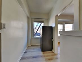San Francisco apartment for rent - a large empty room with a large window and a wooden floor